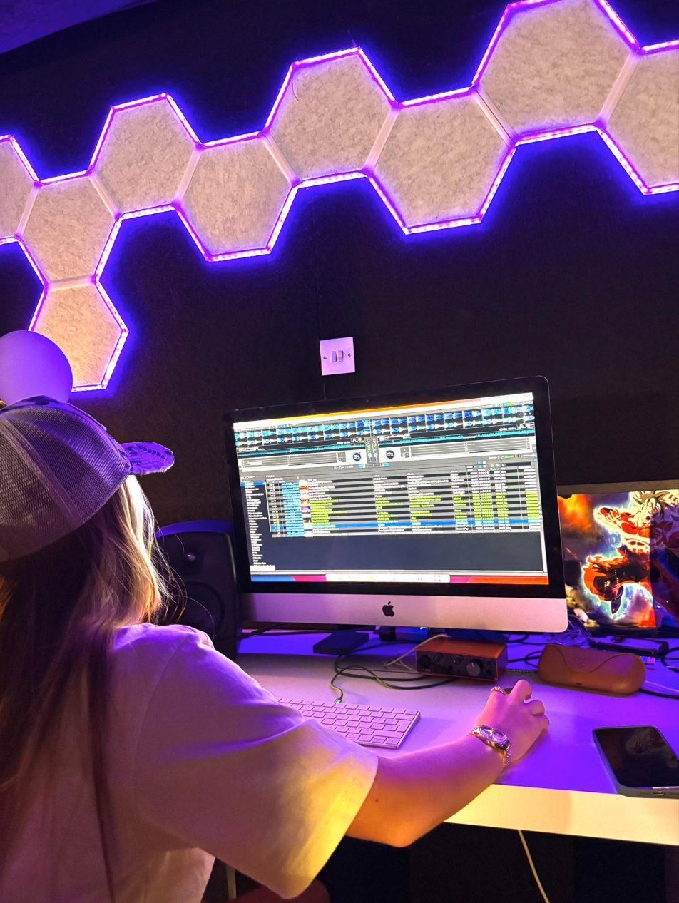 A young person writing a song at the production desk