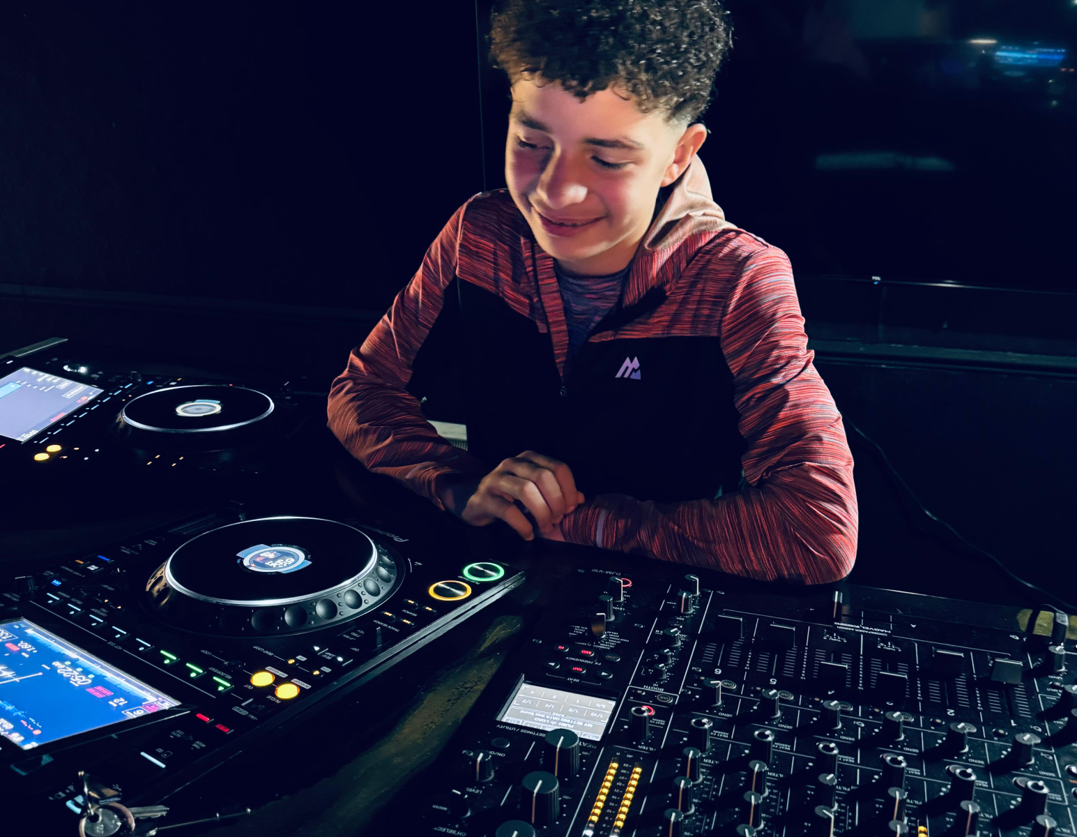 Young boy learning how to DJ